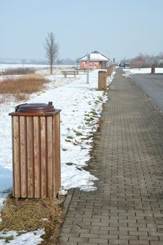 Brown wooden dust bins on parking nearby motorway