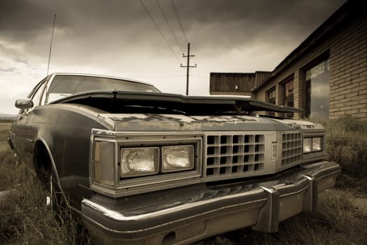 Old abandoned car along the street in the Utah, toned image