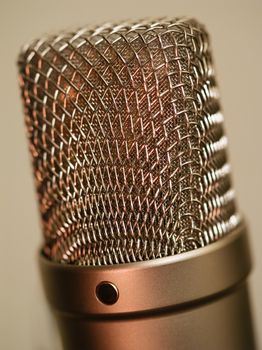 Macro abstract photo of a large diaphragm studio microphone. Shallow depth of field.