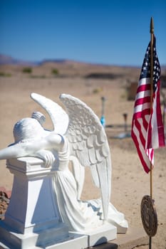 Country cemetery with American Flag and legion medal with tombstones in the background