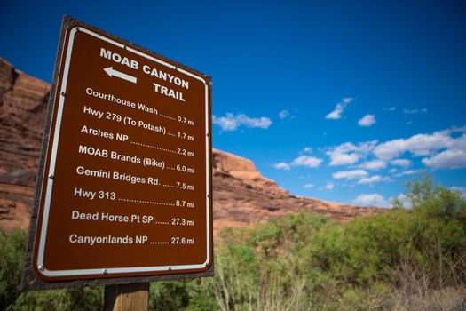 Information sign found at the entrance of Moab city explaining the distances to the different parks, Utah