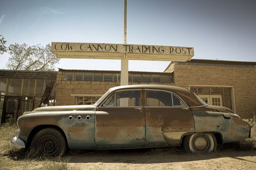 Old abandoned car at the Twin rocks in the Utah, toned image