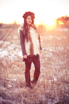 Girl wearing flur vest in winter field lifestyle photo