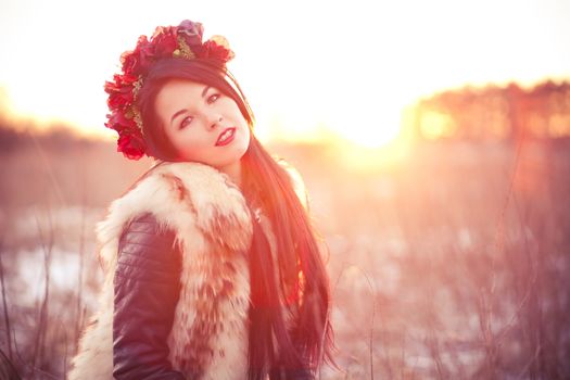 Girl wearing flur vest in winter field lifestyle photo