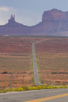 Empty road leading to Monument Valley with clear weather