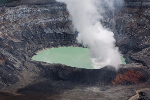 Fumarole smoke over the Poas Volcano in Costa Rica in 2012. Detail of the acid water crater with turquoise colors.