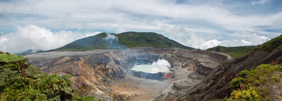 Panoramic view of  fumarole smoke over the Poas Volcano in Costa Rica in 2012. Detail of the acid water crater with turquoise colors.