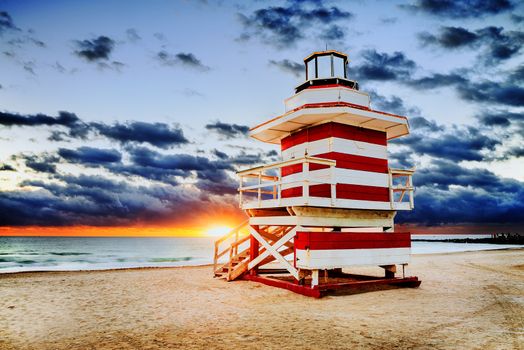 Miami South Beach sunrise with lifeguard tower and coastline with colorful cloud and blue sky. 