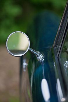 Close up of the mirror of an antique car