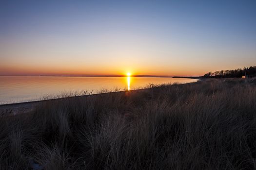 Beautiful sunset above the sea in a lovely beach bay
