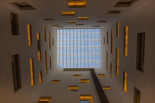 Interior facade of a contemporary design hotel in Barcelona. Composition of windows and yellow lights
