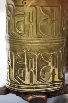 Bronze prayer roll at the Potala Palace , Tibet. The Historic home of the Dalai Lama, Lhasa, Tibet. An UNESCO World Heritage site.