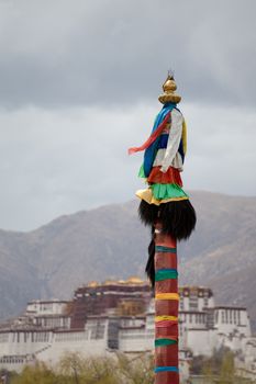 Religious Tibetan symbol with the Potala Palace in the background, Lhasa, Tibet. 2013