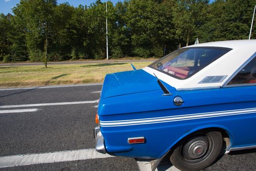 Beautiful blue vintage car on the road on the highway in Belgium