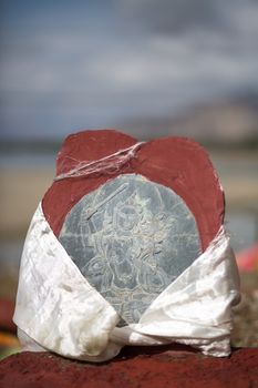 Religious stones with colorful drapes .The road of Friendship in Tibet - Going to Kathmandu