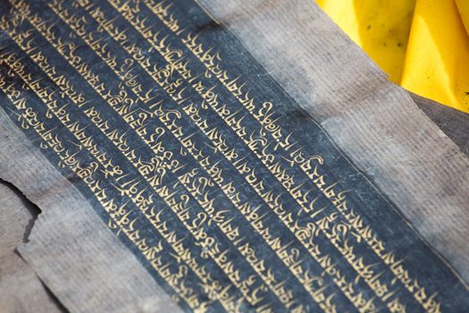 Close up of an old Tibetan manuscript. The kings’ minister Thonmi Sambhota developed the Tibetan script to accommodate the influx of the Buddha’s teachings, Sutra and Tantra manuscripts from India.