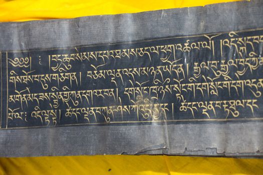 Close up of an old Tibetan manuscript. The kings’ minister Thonmi Sambhota developed the Tibetan script to accommodate the influx of the Buddha’s teachings, Sutra and Tantra manuscripts from India.