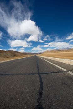 Straight road to Himalayas range on the Friendship Highway in Tibet