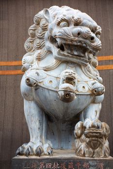 Sculpted stone lion at the entrance of a a temple on The road of Friendship in Tibet