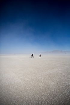 Cyclists riding mountain bikes in the Black Rock Desert in Nevada, USA