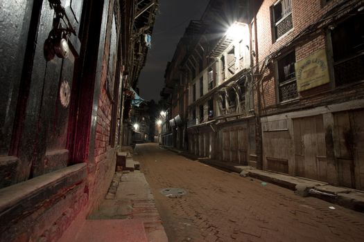 Empty street at night in the old city of Bhaktapur. The old city is a protected UNESCO Heritage site. Long time exposure photo.