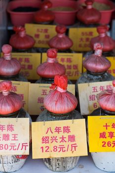 Different sort of tea in a market in Shanghai, the tea is conserved into large pots all identical, China 2013.