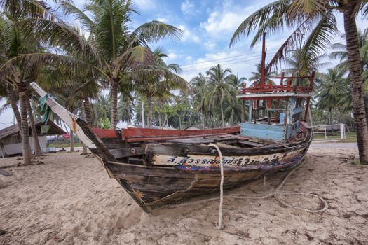 Wreck of fishing boat on a beach in Thailand