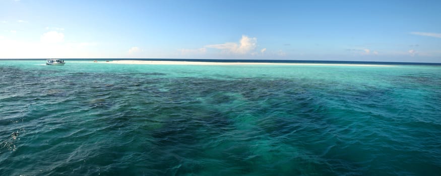 Detail of the Indian Ocean in the Maldives, blue sky and crystal water, Maldives.