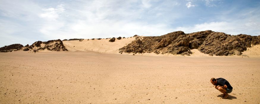 NAMIBIA, SKELETON COAST, DECEMBER 18: A man is looking for diamonds in the forbidden diamond area in the Skeleton Coast Desert in Namibia