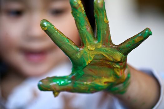 close up of  child face playing with finger painting