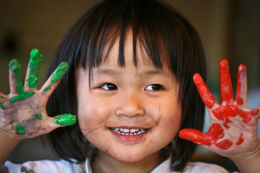 close up of  child face playing with finger painting