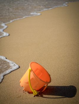 Children's Toy Bucket On A Tropical Beach
