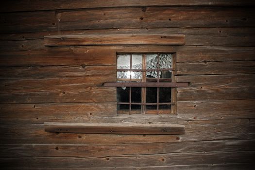 window on old wooden church exterior wall