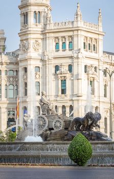 Famous Cibeles fountain in Madrid, Spain, with palace of communications on the background