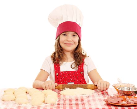 little girl kneading dough with rolling pin
