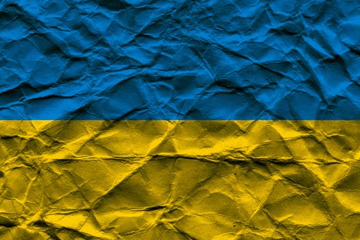 Rumpled National flag of Ukraine with paper texture