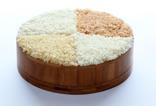 brown and white rice arranged in a wooden box