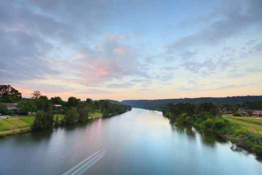 Nepean River looking toward Nepean Gorge and the Blue Mountains on a pretty morning as the sunrises painting the clouds with soft hues.