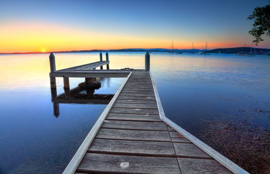 Setting sun on the horizon at Belmont, view from the jetty.