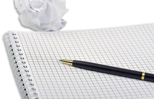 A notebook with ballpoint pen and crumpled paper isolated on a white background with light shadow.