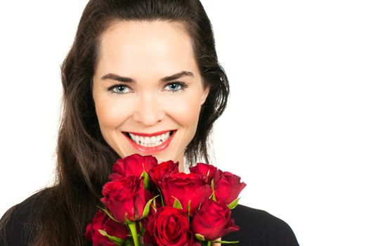 A happy beautiful woman smiling a bunch of roses. Isolated on white.