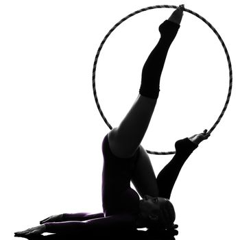 one caucasian woman exercising Rhythmic Gymnastics hula hoop in silhouette studio isolated on white background