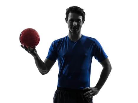 one caucasian young man exercising handball player in silhouette studio on white background