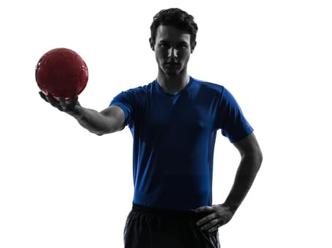 one caucasian young man exercising handball player in silhouette studio on white background