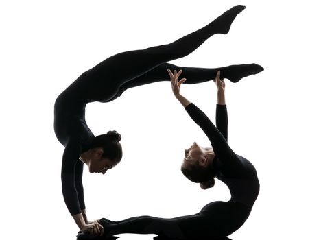 two women contortionist practicing gymnastic yoga in silhouette  on white background