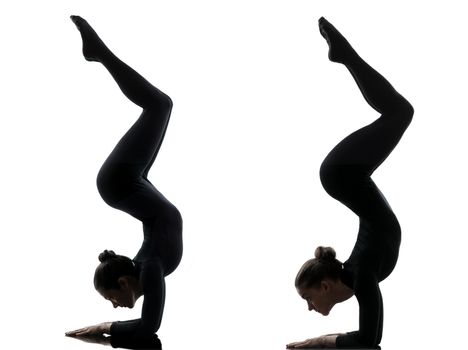 two women contortionist practicing gymnastic yoga in silhouette  on white background