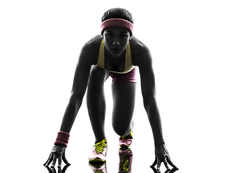 one caucasian woman runner running on starting blocks in silhouette on white background