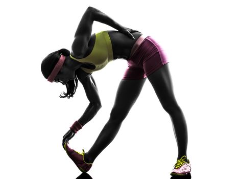 one caucasian woman runner stretching  in silhouette on white background