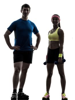 one woman exercising fitness workout with man coach posing in silhouette on white background