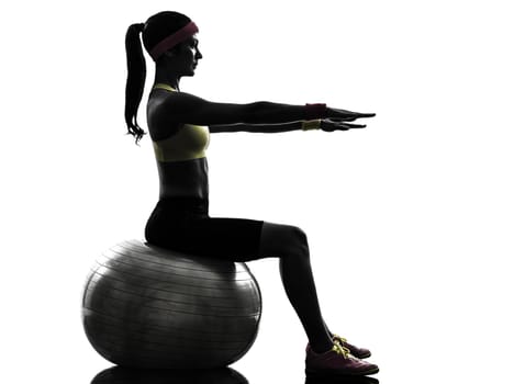 one woman exercising fitness workout on fitness ball in silhouette on white background
